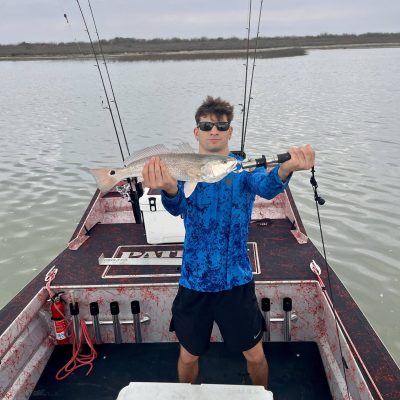 Man posing with fish on 2025 Patriot airboat