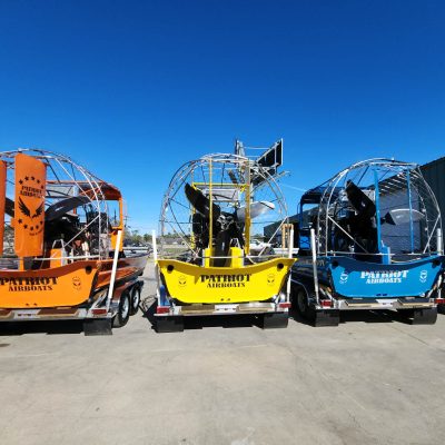 airboat fleet on trailers parked in lot